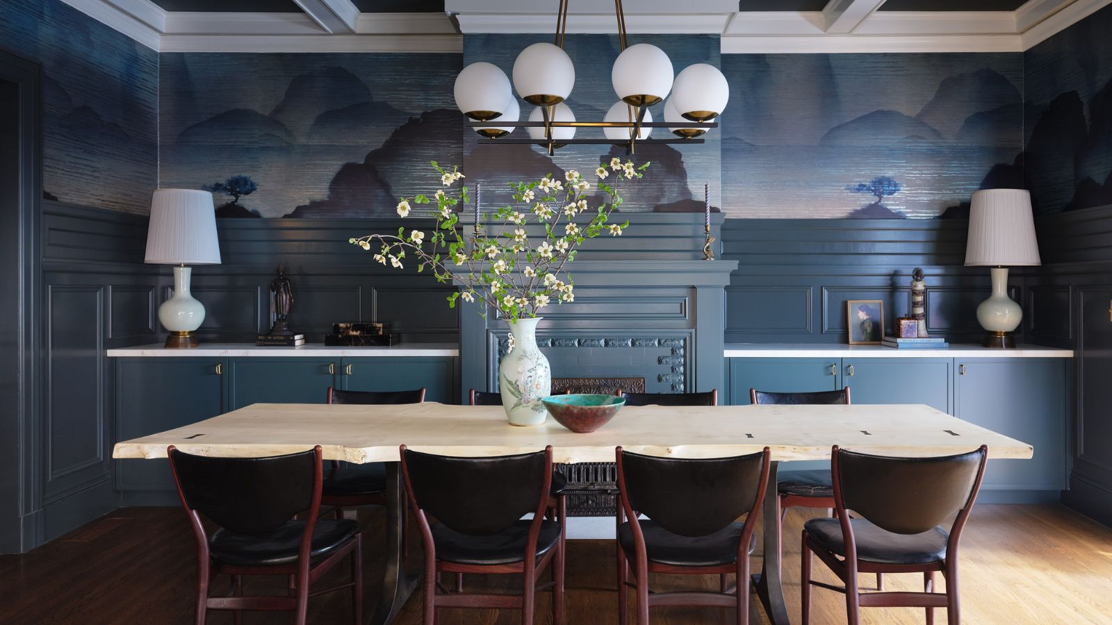 dining room with blue mural walls and paneled ceiling 