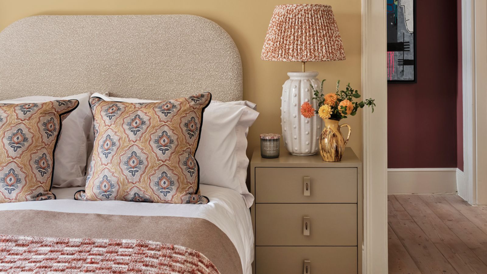Pale yellow bedroom with textured lampshade, throw and pillows