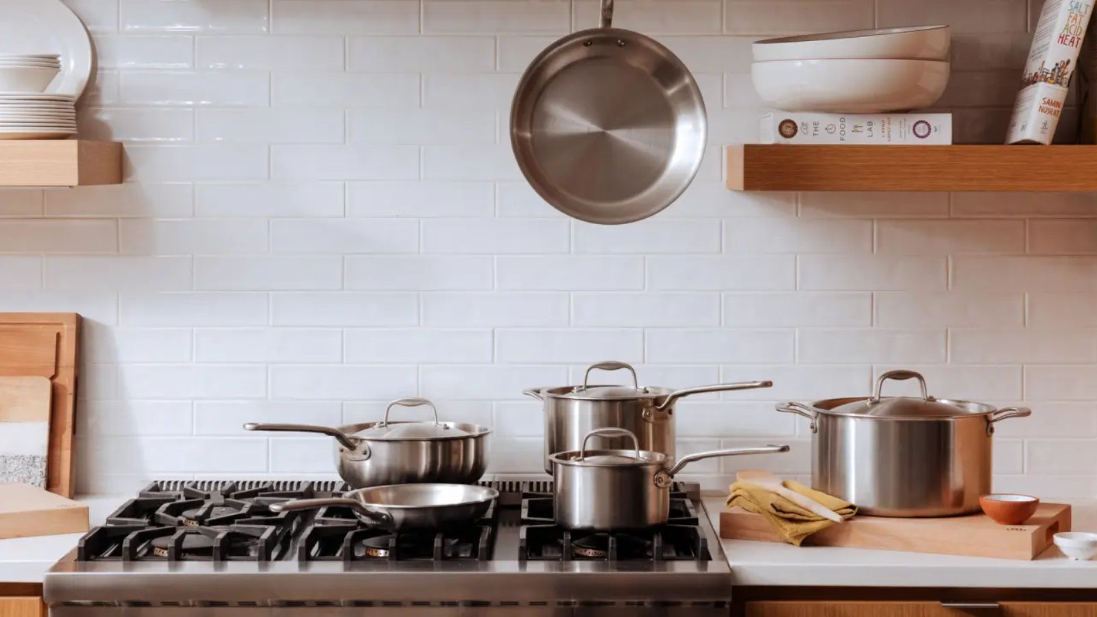 A selection of Made In Stainless Steel Pans on a gas stovetop