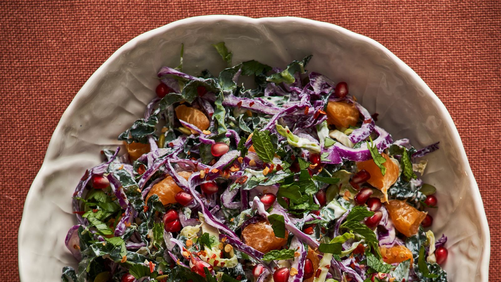 Bowl of winter slaw with red cabbage, orange and pomegranate